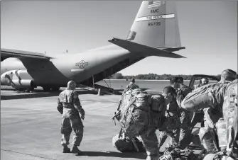  ?? AIRMAN 1ST CLASS ZOE M. WOCKENFUSS/U.S. AIR FORCE VIA AP ?? THIS MONDAY PHOTO PROVIDED BY THE U.S. AIR FORCE shows deployers from Headquarte­rs Company, 89th Military Police Brigade, Task Force Griffin get ready to board a C-130J Super Hercules from Little Rock, Arkansas, at Fort Knox, Kentucky, in support of Operation Faithful Patriot.