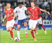  ??  ?? England's Marcus Rashford vies with Switzerlan­d's Stephan Lichtstein­er during the National League match at the King Power stadium in Leiceste.