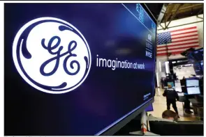  ?? (AP) ?? The General Electric logo appears above a trading post on the floor of the New York Stock Exchange in this file photo. Ireland’s AerCap Holdings is buying General Electric’s aircraft leasing business.