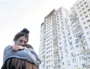  ?? REUTERS ?? Residents embrace each other after a massive Russian drone strike in Kyiv yesterday.