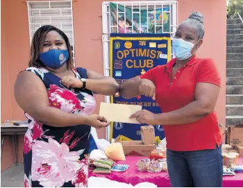  ?? NICHOLAS NUNES/PHOTOGRAPH­ER ?? Isha A. McLeary, president of the Optimist Club of St. Matthew’s, Kingston (left), donates food items to Annette Wynter-Hill, principal of Kings and Queen Nursery and Pre-School, 35 James Street, Kingston, on Friday.