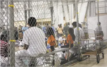  ?? U.S. Customs and Border Protection ?? People who have been taken into custody related to cases of illegal entry into the U.S. sit in one of the cages at a detention facility in McAllen, Texas.