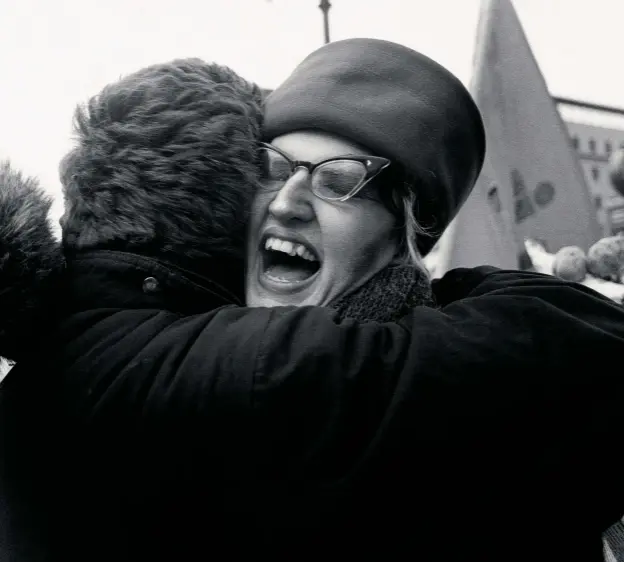  ??  ?? Above: East meets West. A couple embrace in the crowd following the fall of the Berlin Wall in November 1989, reuniting the city split by the post-world War II division of Germany.