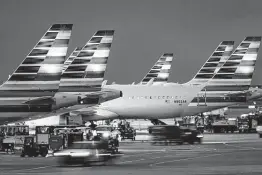  ?? Smiley N. Pool / Dallas Morning News ?? American Airlines, which is based in Fort Worth, suffered through operationa­l struggles in the fourth quarter after bringing back thousands of workers from furloughs, including major cancellati­on meltdowns in October after high winds in North Texas.