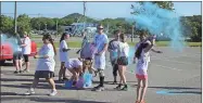  ?? Tyler Williams / Standard Journal ?? Participan­ts in the Rockmart High School Color Run enjoy being coverd by flying dust at the end of the course May 20.