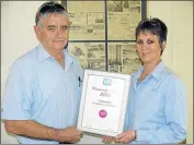  ?? Pictures: ?? WOW: PG Glass in Grahamstow­n has won the national “PG Helping Hands Hero of the Year” award for its contributi­on towards community involvemen­t. With the award are PG Glass franchise owner Tim Dold (left) and admin manager Marilyn Tesnar. See story on...