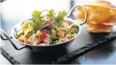  ??  ?? Ceviche Acapulco is seasoned fish, shrimp, crab, jalapeño, cilantro, cucumber and avocado served with chips.