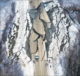  ?? Marc Lester Anchorage Daily News ?? WASILLA’S Vine Road, above, saw serious damage. So did the Glenn Highway, which connects communitie­s along 180 miles heading northeast from Anchorage.