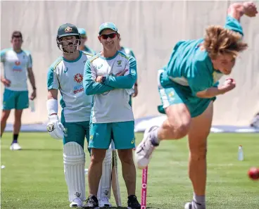  ??  ?? A file photo of Australia's David Warner (left) and coach Justin Langer watch Cameron Green bowl during a training session