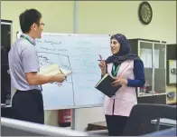  ?? PAN CHAOYUE / XINHUA ?? Above: An Egyptian executive interacts with her Chinese colleague for a project in the economic and trade zone around the Suez Canal. ZHAO DINGZHE / XINHUA Right: A researcher at work at a Chinese enterprise in Egypt.