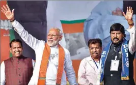  ?? PTI ?? Prime Minister Narendra Modi with RPI leader Ramdas Athawale waves at the crowd during an election rally ahead of Maharashtr­a Assembly elections, at Kharghar in Navi Mumbai, Wednesday