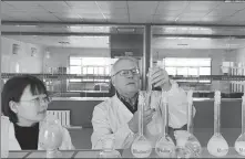  ?? ?? laboratory in Hengshui. Right: Merz conducts reagent experiment­s in a