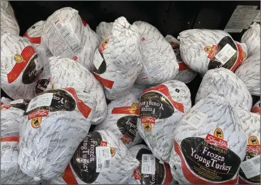  ?? (AP/Matt Rourke) ?? Frozen turkeys are displayed at a supermarke­t in Philadelph­ia, in November 2021.