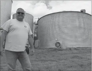  ?? STAFF PHOTO BY SARA NEWMAN ?? Chip Bowling stands in front of silos at his farm, Bunker Hill Farm in Newburg. The Bowling family was named 2016 Charles County Farm Family of the Year by members of the Charles County agricultur­al community.