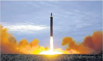 ??  ?? North Korea’s intermedia­te-range strategic ballistic rocket Hwasong-12 lifts off on Aug 29.