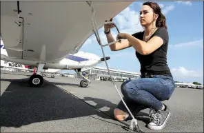  ?? Arkansas Democrat-Gazette/THOMAS METTHE ?? Student Grace Harrison goes through a pre-flight check of an airplane at Central Flying Service on Thursday.