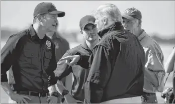  ?? AP PHOTO ?? FEMA director Brock Long, left, talks with President Donald Trump after he arrives at Eglin Air Force Base to visit areas affected by Hurricane Michael Monday in Eglin Air Force Base, Fla.