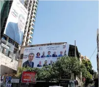  ?? (Mohamed Azakir/Reuters) ?? POSTERS WITH Lebanese parliament candidates are seen on buildings in Beirut on Monday.