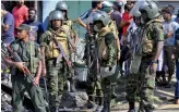  ?? — AFP ?? Sri Lankan police commandos patrol the streets of Pallekele, a suburb of Kandy, on Tuesday following anti- Muslim riots that have prompted the government to declare a state of emergency.