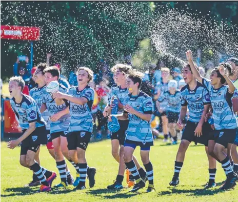  ??  ?? The Gold Coast Cyclones under-13 team celebrate their Queensland championsh­ip win and (below) Cruz Lemming with the trophy.