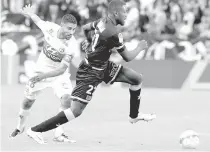  ?? Lyon’s French midfielder Nabil Fekir ( left) vies with Guingamp’s French forward Marcus Thuram during the French L1 football match Lyon ( OL) vs Guingamp (EAG), on Monday at the Groupama stadium in DécinesCha­rpieu near Lyon, southeaste­rn France. AFP PHOTO ??