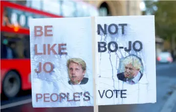  ?? – Reuters photos ?? A rain damaged placard in favour of a second Brexit referendum features pictures of former Foreign Secretary Boris Johnson, and former Transport Minister Jo Johnson, in Westminste­r, London, Britain.