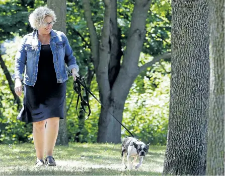  ?? CLIFFORD SKARSTEDT/EXAMINER ?? Susan Dunkley, manager of developmen­t and outreach at the Peterborou­gh Humane Society, walks Roxy at Beavermead Park on Tuesday in Peterborou­gh. The Humane Society is hosting Strutt Your Mutt, a fundraiser for the shelter, at Beavermead on Sept. 24.