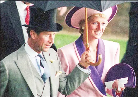  ??  ?? In this June 20, 1990 file photo, Britain’s Princess Diana and Prince Charles, take shelter under an umbrella while attending the second day of the Royal Ascot horse race
meet near London. (AP)