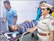  ?? SAMEER SEHGAL/HT ?? Gurpreet Singh, who was injured in the clash, being treated at civil hospital Amritsar; and (right) Police examining the damaged bus where the clash between the two groups took place at the bus stand in Amritsar on Thursday.