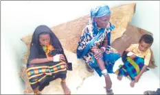  ??  ?? A woman and her two children await treatment at Dukana dispensary in Marsabit recently. Over 1000 people have tested positive for malaria and officials fear the outbreak may not end soon