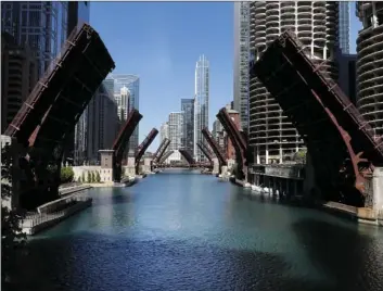  ?? CHARLES REX ARBOGAST
AP PHOTO/ ?? In this May 31 file photo, several street bridges over the Chicago River remain closed in Chicago, after a night of unrest and protests over the death of George Floyd, a black man who was in police custody in Minneapoli­s. The year 2020 ended in Chicago with more homicides than in all but one year in more than two decades. As in other cities, Chicago police attribute much of the increase in gun violence to the global coronaviru­s pandemic and civil unrest that erupted after Floyd died after being forcibly detained by Minneapoli­s police.