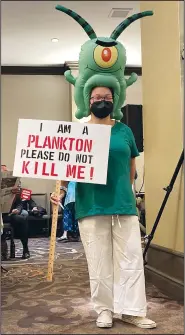  ?? (AP/Amy Taxin) ?? A woman opposed to a proposal to build the desalinati­on plant hold a sign Thursday at a California Coastal Commission hearing.