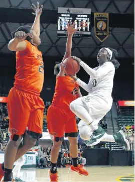  ?? [AP PHOTO] ?? Baylor guard Alexis Jones, right, drives on OSU guard Sydney Walton, center, and forward LaTashia Jones, left, during Wednesday night’s matchup in Waco, Texas.