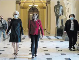  ?? ALEX WONG GETTY IMAGES ?? In a private conference call with Democrats, House Speaker Nancy Pelosi, centre, said “we must take action” following Wednesday’s siege of the Capitol by a pro-Trump mob that left five dead.