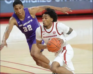  ?? (NWA Democrat-Gazette/Andy Shupe) ?? Arkansas guard Desi Sills (right) drives to the lane as he is pursued by Abilene Christian forward Joe Pleasant in the Razorbacks’ 85-72 victory on Tuesday. Sills is the lone returnee to play in every game this season for the Razorbacks, who have managed to get in all eight of their scheduled games — all victories.