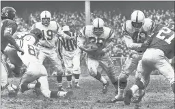  ?? BALTIMORE SUN ?? Baltimore Colts running back Alan Ameche finds a wide hole on a rushing play in the championsh­ip game against the New York Giants on Dec. 28, 1958.
