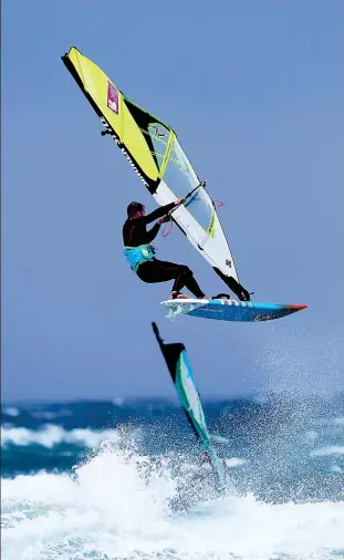  ??  ?? High winds: A windsurfer feels the force as the gales reach Tiree