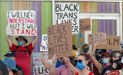  ?? Keith Srakocic/Associated Press ?? Protesters wave signs June 6 during a Black Lives Matter rally in Pittsburgh.