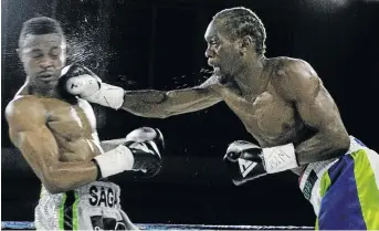  ?? / VELI NHLAPO ?? Nkululeko 'Bull Dog' Mhlongo lands a powerful punch on Emanny Kalombo but went on to lose the bout at Edenvale Community Centre.