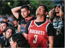  ?? Elizabeth Conley / Houston Chronicle ?? Unhappy Rockets fans, including Angel Rendon, left, and Michael Salamanea, right, watch at Lucky’s Pub in Houston as the Warriors take control of Game 7.