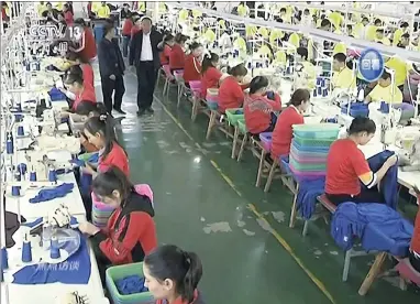  ??  ?? In this file image from undated video footage run by China’s CCTV via AP Video, Muslim trainees work in a garment factory at the Hotan Vocational Education and Training Center in Hotan, Xinjiang, northwest China. A US company that stocks college bookstores with T-shirts and other team apparel cut ties on Wednesday, January 9 with a Chinese company that drew workers from an internment camp holding targeted members of ethnic minority groups.