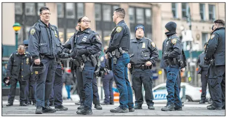  ?? Eduardo Munoz Alvarez The Associated Press ?? New York Police officers wait for instructio­ns Wednesday near a courthouse in New York ahead of former President
Donald Trump’s anticipate­d indictment. A New York grand jury investigat­ing Trump appears poised to complete its work.