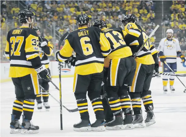  ?? — GETTY IMAGES FILES ?? Nick Bonino of the Pittsburgh Penguins was helped off the ice by teammates after blocking a shot during Game 2 of the Stanley Cup Final in Pittsburgh. He missed Saturday’s Game 3 in Nashville and remains a game-time decision for Monday’s Game 4.