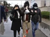  ?? BIZUAYEHU TESFAYE — LAS VEGAS REVIEW-JOURNAL VIA AP ?? Former FBI informant Alexander Smirnov, center, leaves a courthouse in Las Vegas on Tuesday.