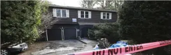  ?? NiColaus CzarNeCki pHotos / Herald staff ?? SHE TRIED TO SAVE THEM: A woman was killed after she ran back in her burning home to try to save more than a dozen dogs in Holliston on Monday night. All the dogs also died. Below, an animal cage is left in the front yard Tuesday.