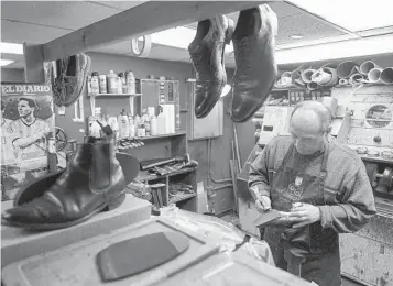  ?? MARY ALTAFFER AP ?? An employee repairs a pair of women's shoes at the Alpha Shoe Repair Corp. in New York. Shoe repairs typically bring in more money than shines.