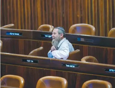  ?? (Olivier Fitoussi/Flash90) ?? MK AVI Maoz sits among empty seats in the Knesset plenum.
