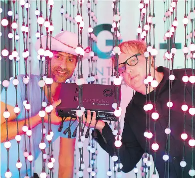  ??  ?? Limbic Media transforms public spaces with high-tech reactive art and light installati­ons that invite participat­ion and bring people together. Owners Manjinder Benning and Justin Love stand among a string of voice-activated lights at Limbic Media’s...