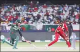  ?? ?? Bangladesh’s batsman Mushfiqur Rahim, (left), runs and survives a run out attempt by Oman’s Mohammad Nadeem during the Cricket Twenty20 World Cup first round match between Oman and Bangladesh in Muscat, Oman. (AP)
