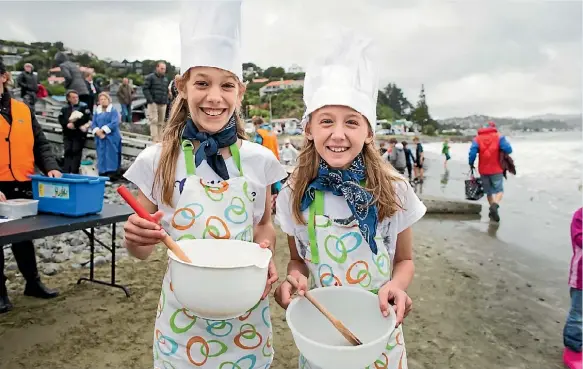  ??  ?? Erin Anderson, left, and Saskia Janssen were well in the mix for the Plimmerton Midwinter Dip on Sunday. The rain and cold couldn’t keep more than 250 people from attending Plimmerton Kindergart­en’s main fundraiser – 120 of whom went into the water –...